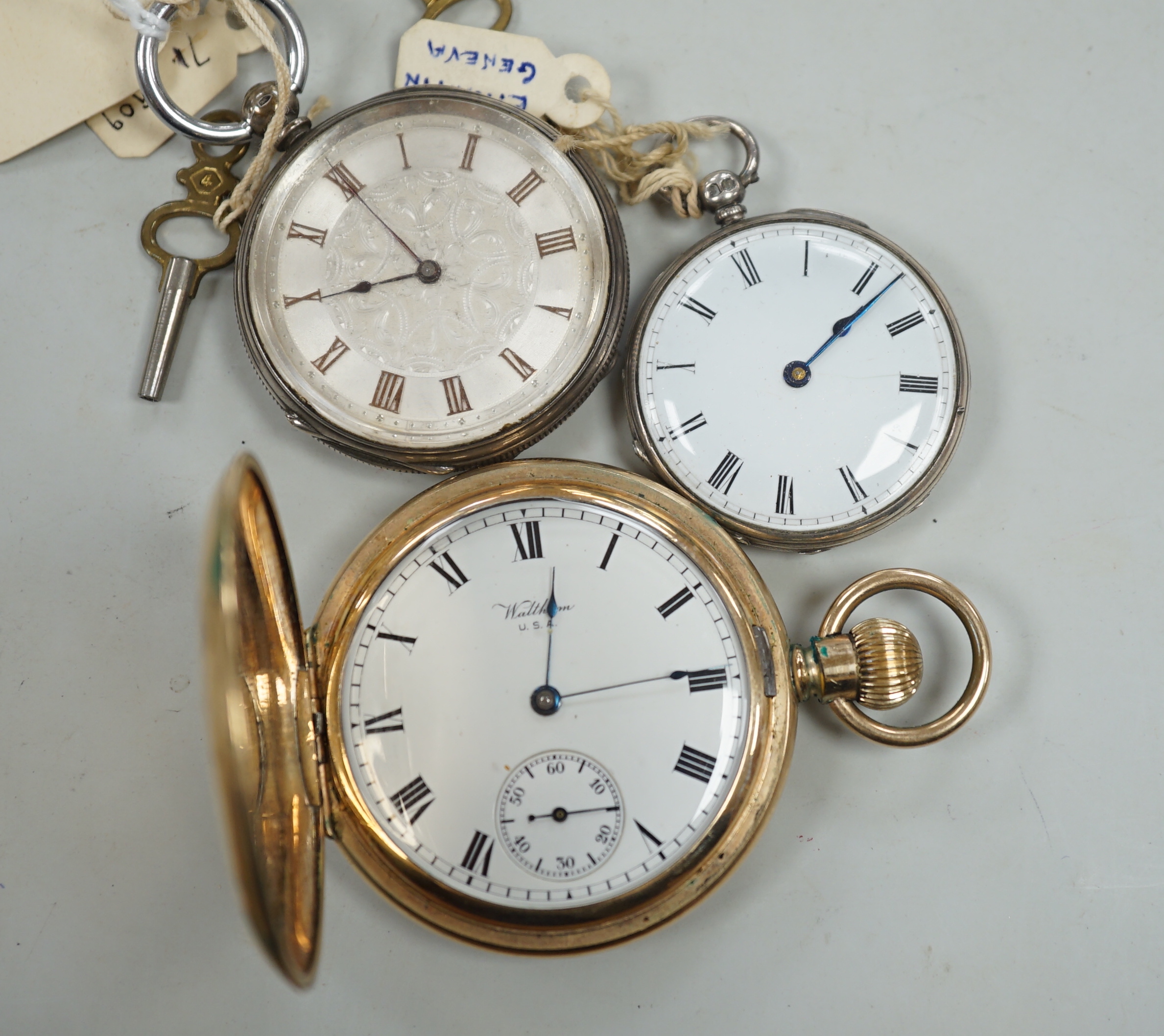 A Waltham gold plated hunter pocket watch and two fob watches, one silver.